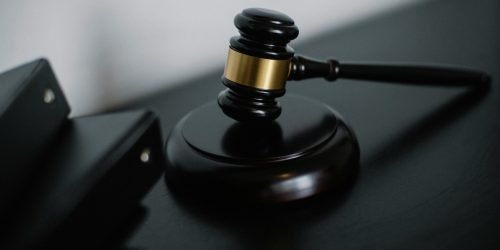 Close-up of a wooden gavel on a desk, symbolizing justice and legal authority.